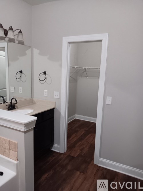 A bathroom with a white sink and a white door.