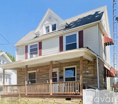 A two-story house with a red and white striped siding.