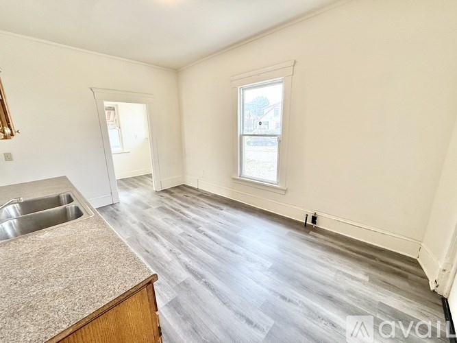 A room with a window and a sink.