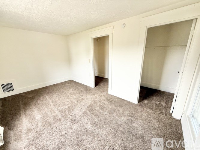 A room with carpeted floor and white walls.