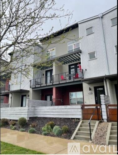A building with a balcony and a door with a window above it.