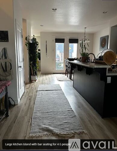 A large kitchen island with bar seating for 4-5 people.