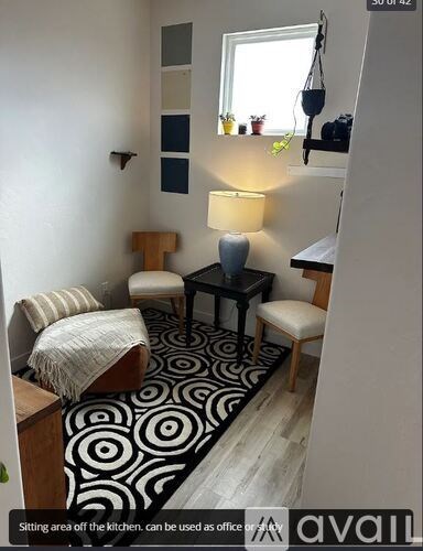 A living room with a couch, chair, and a table.