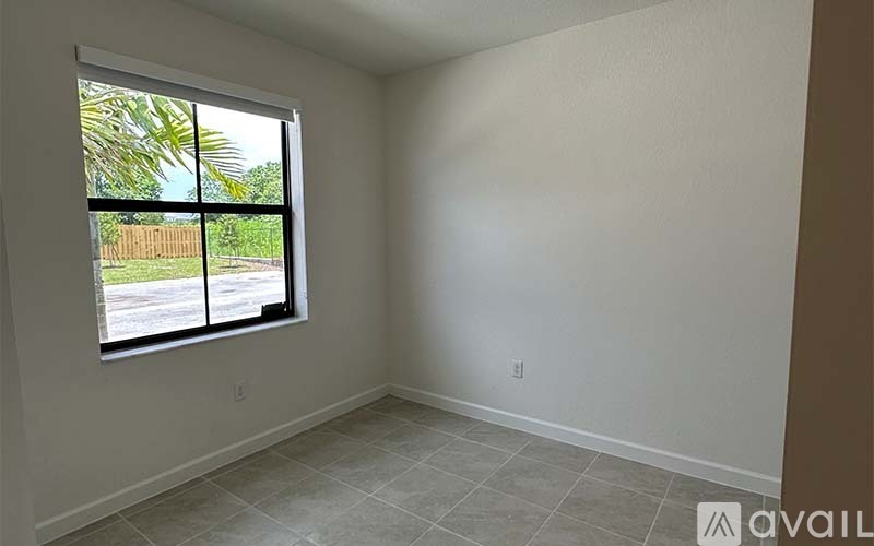 A room with a large window and tiled floor.