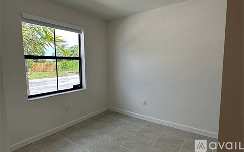 A room with a large window and tiled floor.