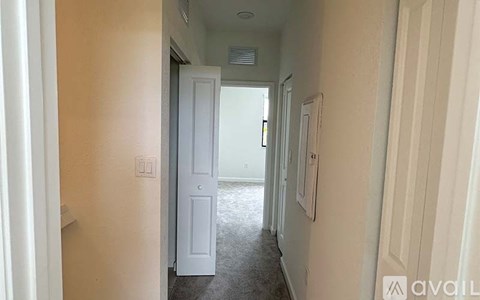 A hallway with a door at the end.