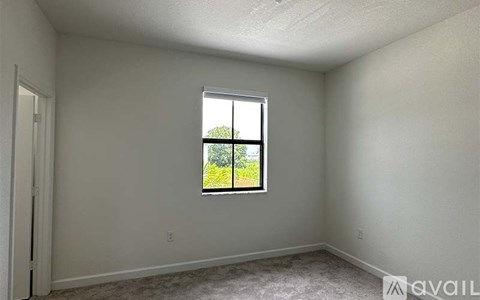 A room with a window showing a green outdoor view.