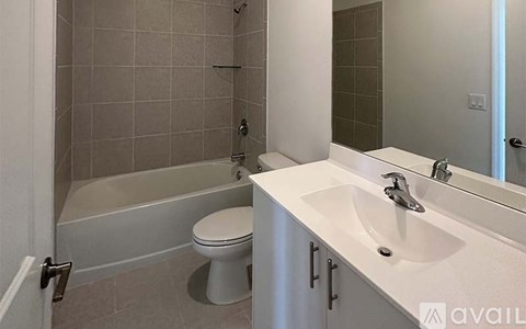 A bathroom with a toilet, sink, and bathtub.