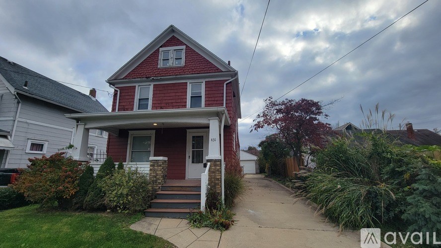 A red house with a white porch and a sign that says "available".