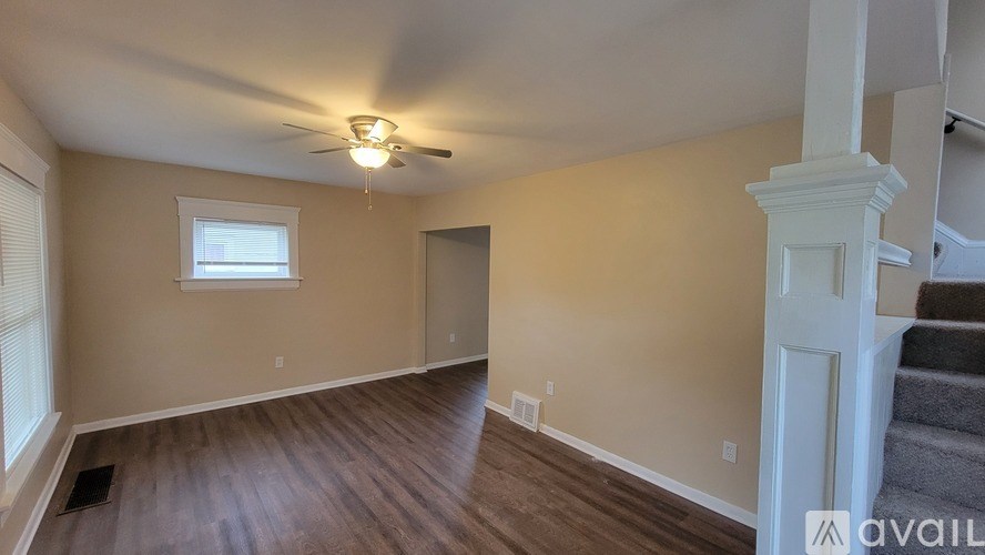 A room with a ceiling fan and a window.