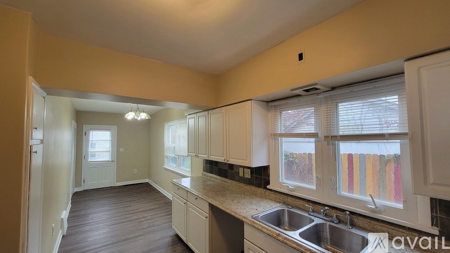 A kitchen with a sink and a window.
