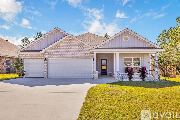 A house with a garage and a driveway in front.