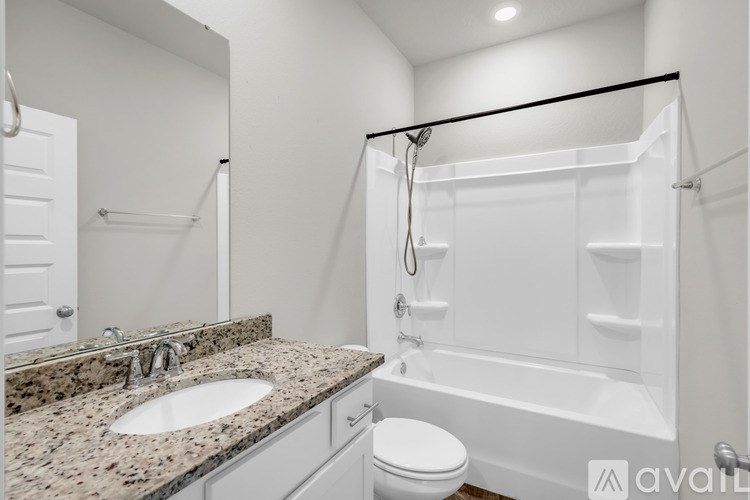 A bathroom with a sink, toilet, and bathtub.
