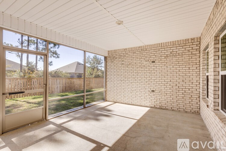 A room with a sliding glass door leading to a backyard.