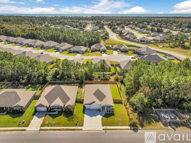 A bird's eye view of a suburban neighborhood with houses and trees.