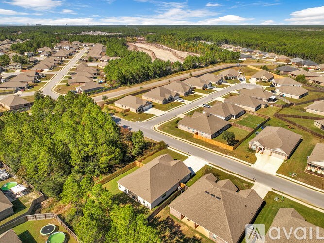 A bird's eye view of a residential area with houses and trees.
