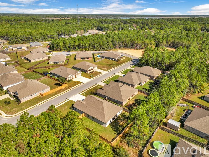 A bird's eye view of a residential area with houses and trees.