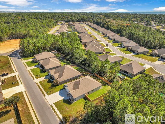 A bird's eye view of a residential neighborhood with houses and trees.