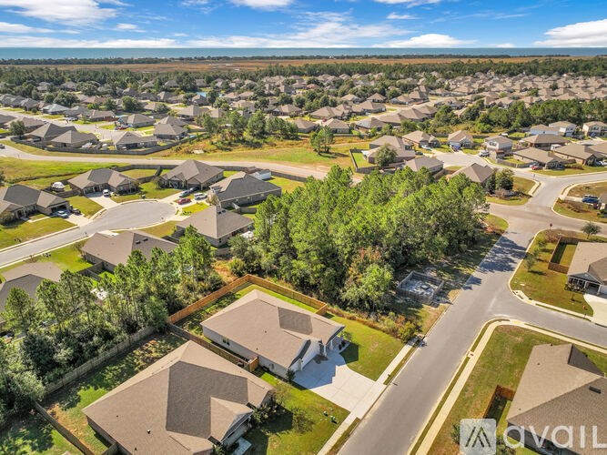 A bird's eye view of a residential area with houses and roads.
