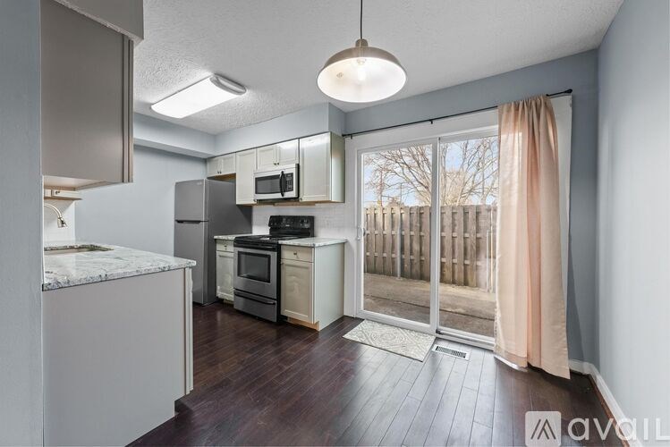 A kitchen with a marble countertop and stainless steel appliances.