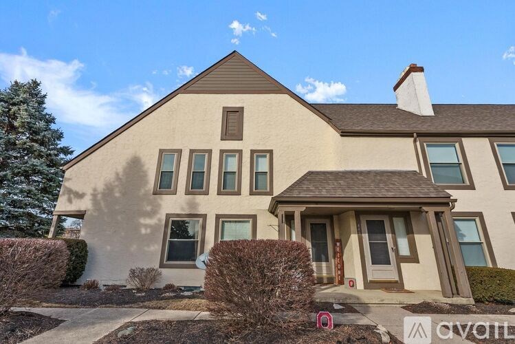 A house with a brown roof and a white chimney is for sale.