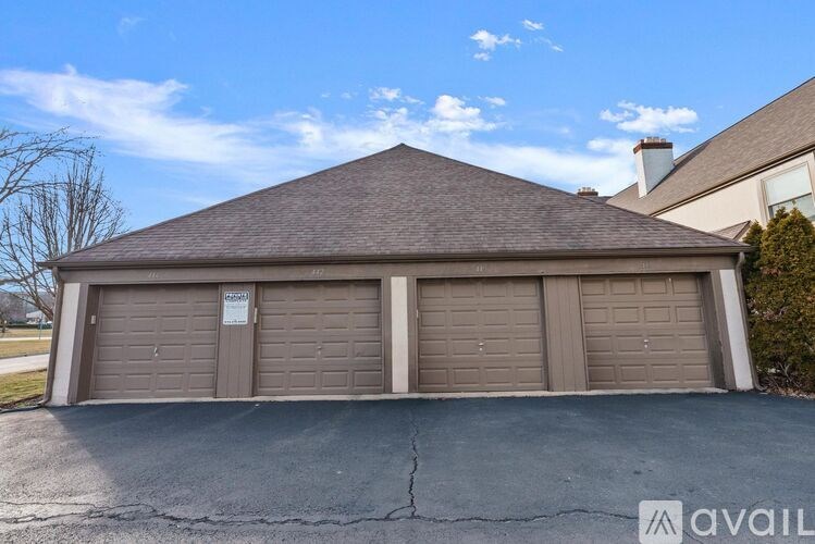 A detached house with a brown garage door.