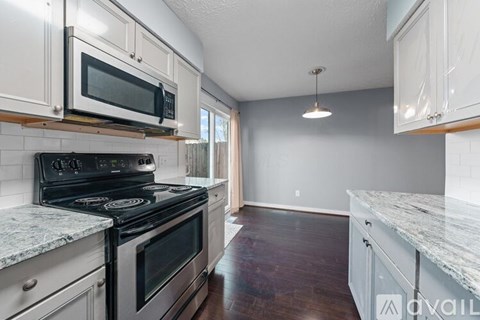A kitchen with a stove top oven and microwave above it.