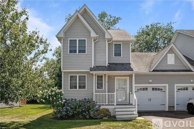 A two-story house with a garage is for sale.