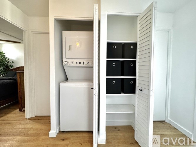 A white oven is built into a cabinet in a kitchen.