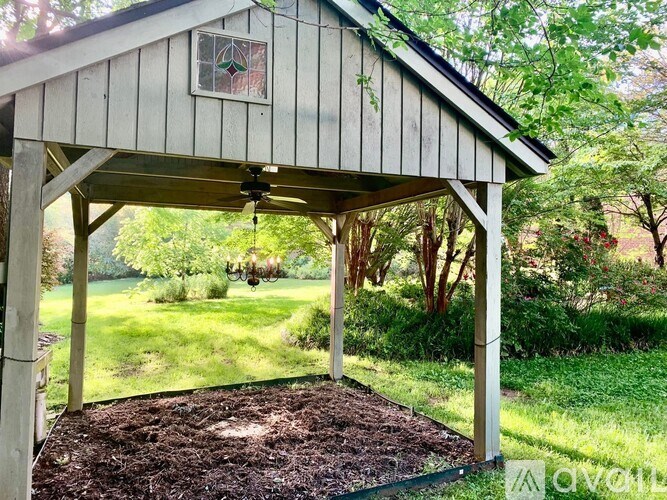 A wooden structure with a green lawn in the background.