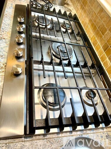 A close up of a stove top with four burners.