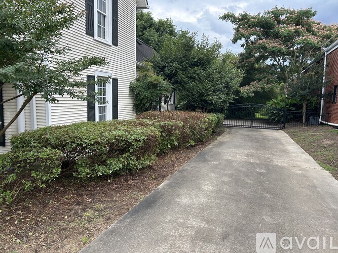 A white house with a driveway in front of it.