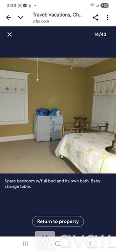 A room with a bed and a baby change table is available for rent.