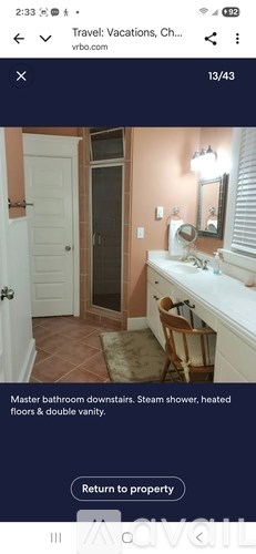 A bathroom with a sink, mirror, and a shower with a glass door.