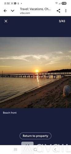 A beachfront with a sunset in the background.