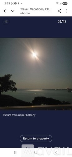 A sunny day with a view of the sea from a balcony.