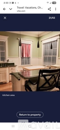 A kitchen area with a table and chairs.