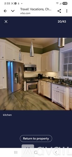 A kitchen with white cabinets and a black stove top oven.