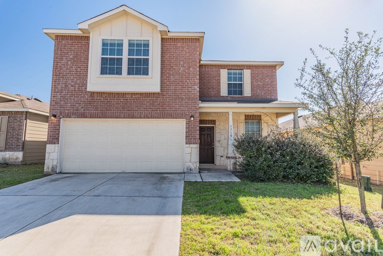 A house with a garage and a driveway in front.