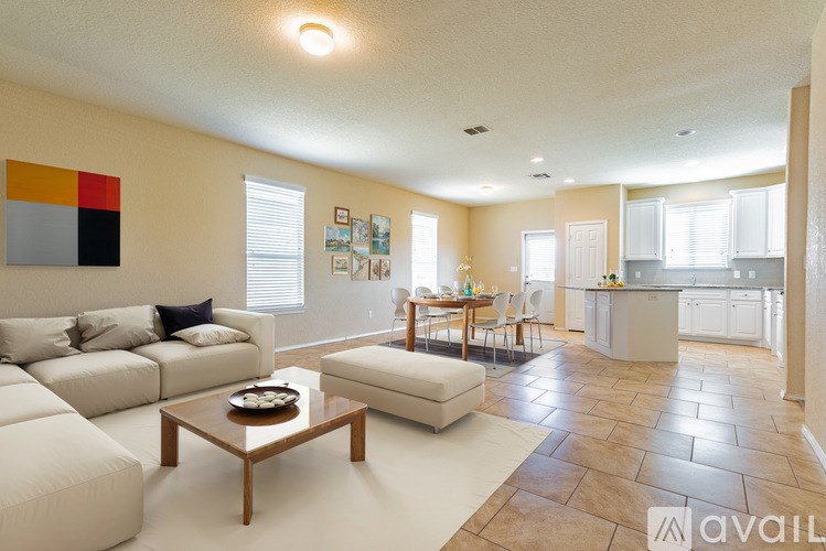 A living room with a white couch and a coffee table.