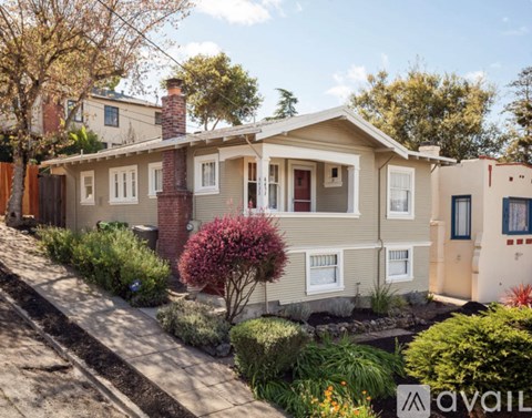 A house with a garden in front of it is for sale.