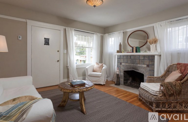 A living room with a fireplace and a sofa.
