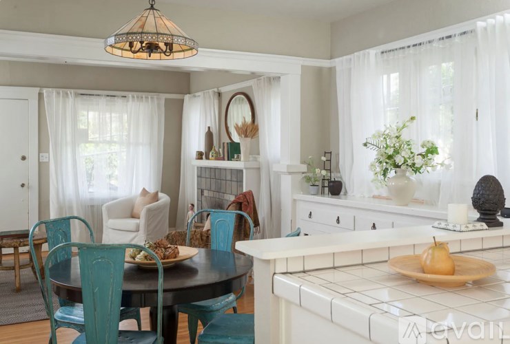 A dining room with a table set for a meal.