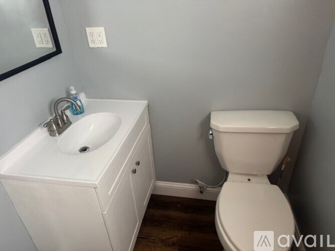 A white sink and toilet in a small bathroom.