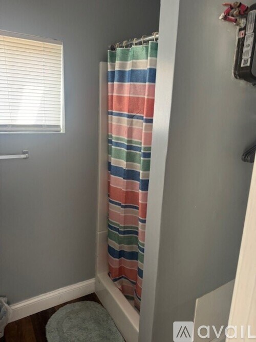 A striped shower curtain in a bathroom.