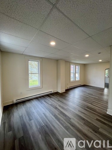 A room with wooden floors and white walls.