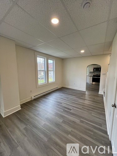 A room with a grey floor and white walls.
