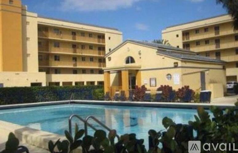 A pool in front of a building with a sign that says "available".