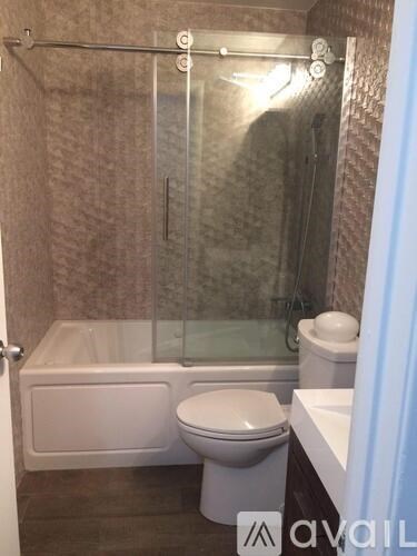 A bathroom with a toilet, tub, and shower.