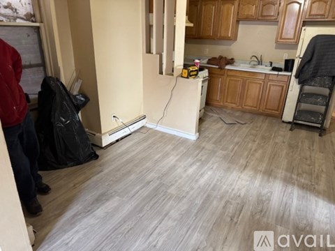 A kitchen with wooden cabinets and a white refrigerator.